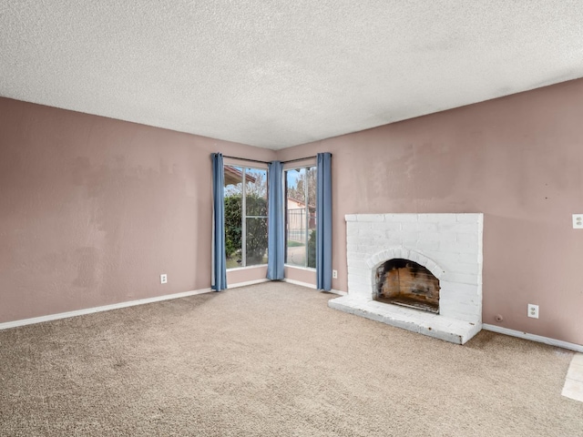 unfurnished living room with carpet, a fireplace, baseboards, and a textured ceiling