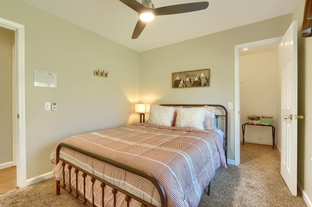 bedroom with ceiling fan, carpet flooring, and baseboards