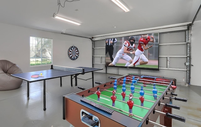 game room with a garage and concrete floors