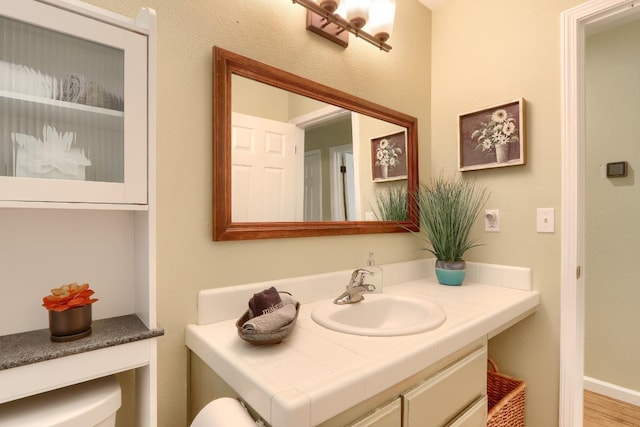 bathroom featuring toilet and vanity