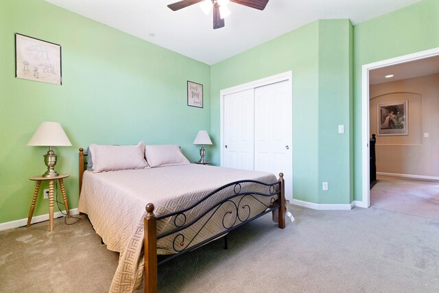 bedroom with ceiling fan, a closet, carpet flooring, and baseboards