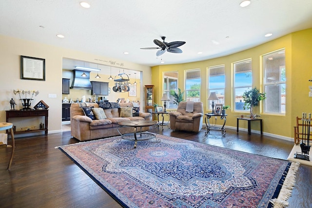 living room featuring recessed lighting, dark wood-style flooring, ceiling fan, and baseboards