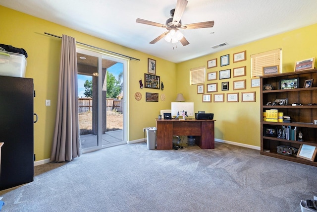 office area with carpet floors, baseboards, visible vents, and ceiling fan