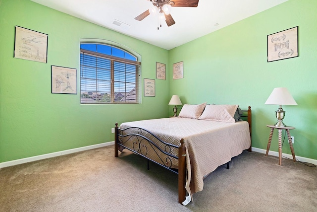 carpeted bedroom with baseboards, visible vents, and a ceiling fan