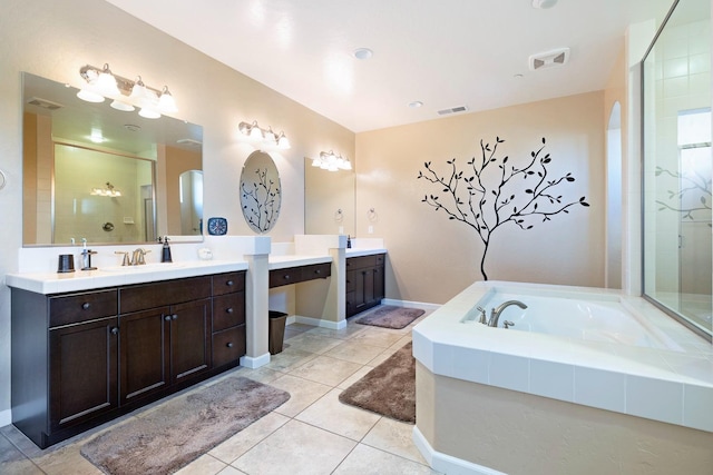 full bath featuring a sink, two vanities, a shower stall, a bath, and tile patterned floors