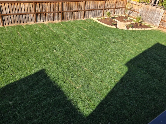 view of yard with a fenced backyard