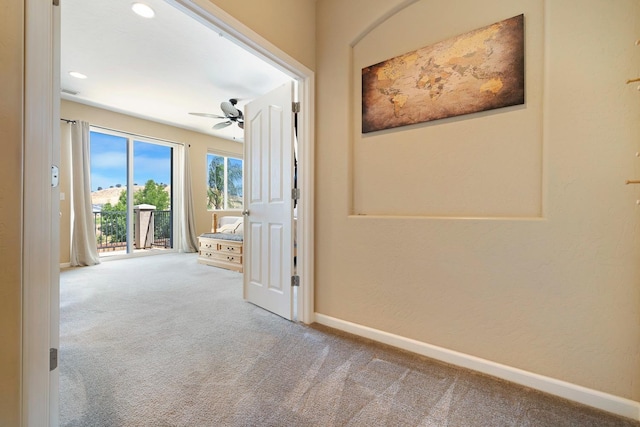 corridor with carpet and baseboards