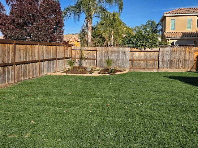 view of yard with a fenced backyard