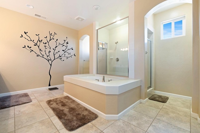 full bathroom featuring a stall shower, tile patterned flooring, visible vents, and baseboards