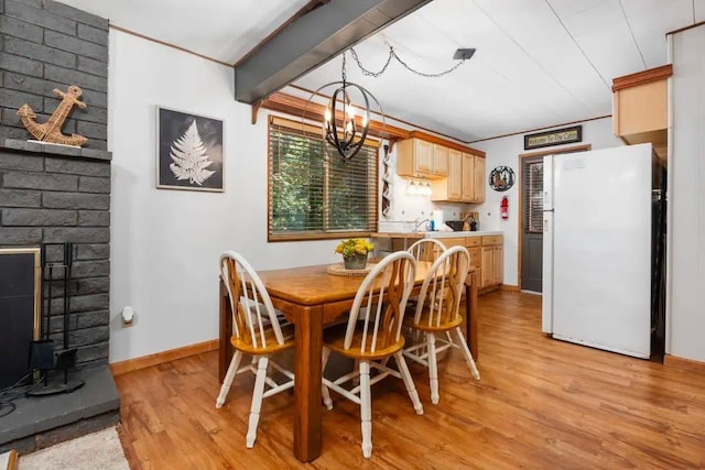 dining area with light wood-style flooring, baseboards, a chandelier, and beam ceiling