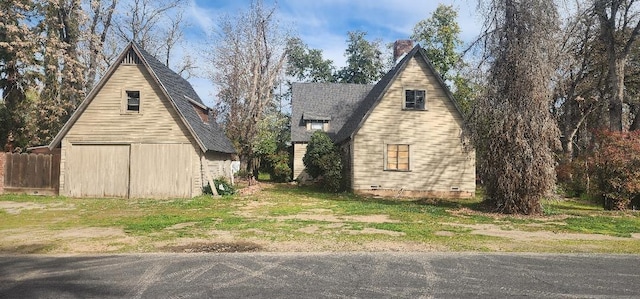 view of home's exterior with a barn, a garage, and an outdoor structure