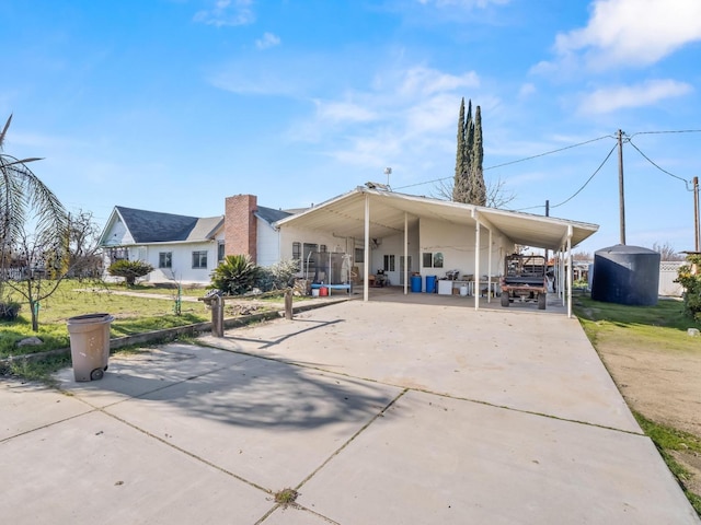 view of front of house featuring an attached carport and concrete driveway