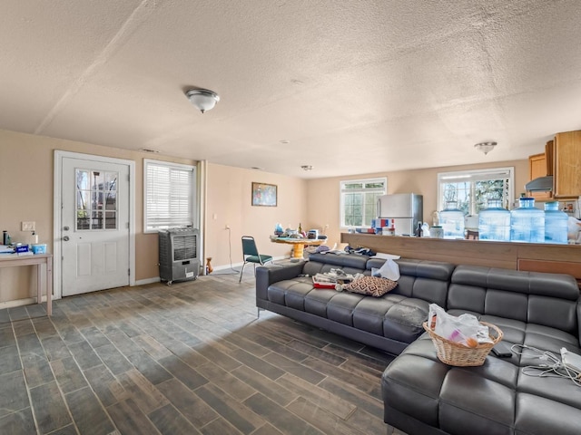 living room featuring a textured ceiling, dark wood finished floors, and baseboards