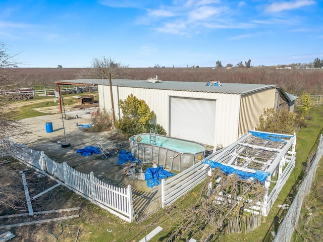 exterior space with an outdoor pool and fence