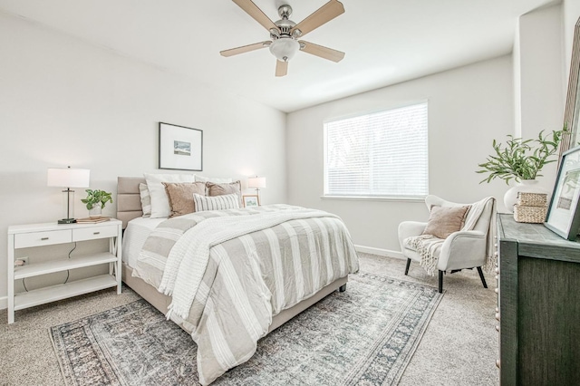 bedroom featuring a ceiling fan, carpet, and baseboards