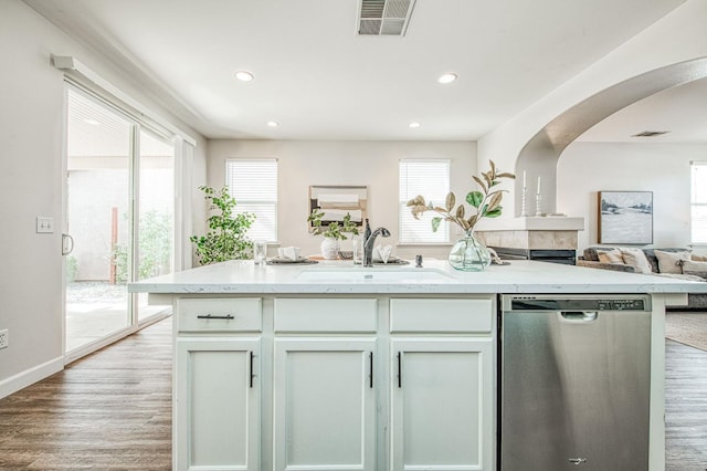 kitchen featuring a wealth of natural light, visible vents, dishwasher, and a sink