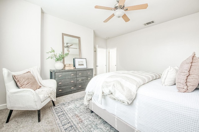 carpeted bedroom with visible vents and a ceiling fan