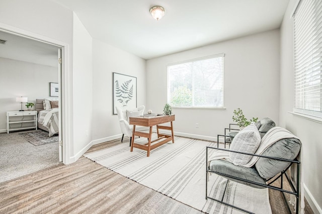 office featuring wood finished floors, visible vents, and baseboards