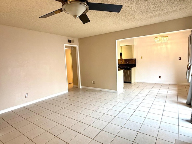 unfurnished room featuring light tile patterned floors, ceiling fan, visible vents, and baseboards