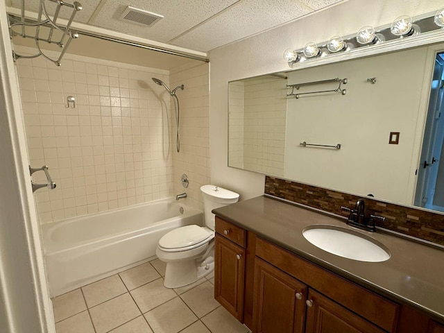 bathroom featuring toilet, visible vents, bathing tub / shower combination, vanity, and tile patterned floors