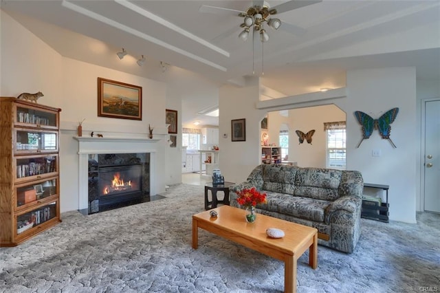 carpeted living area featuring ceiling fan and a premium fireplace