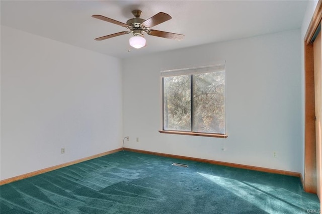 spare room with a ceiling fan, baseboards, visible vents, and carpet flooring