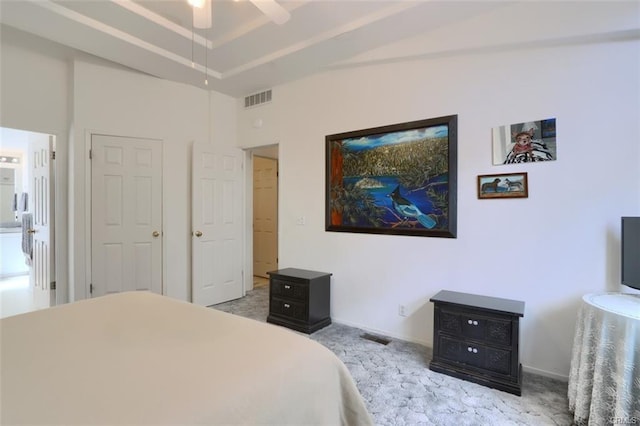 carpeted bedroom with ceiling fan, baseboards, visible vents, and a raised ceiling