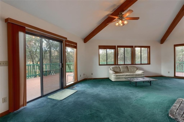 unfurnished living room featuring carpet floors, vaulted ceiling with beams, baseboards, and a healthy amount of sunlight