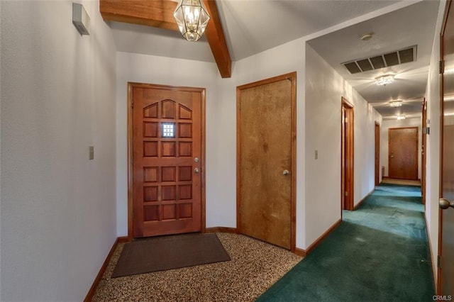 carpeted foyer entrance with beam ceiling, visible vents, and baseboards