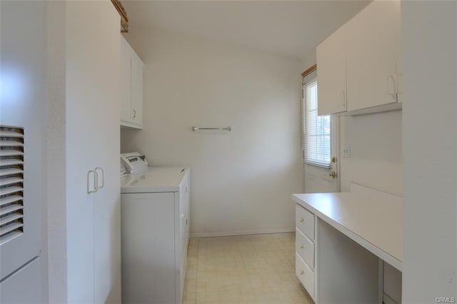 washroom featuring light floors, separate washer and dryer, cabinet space, and baseboards