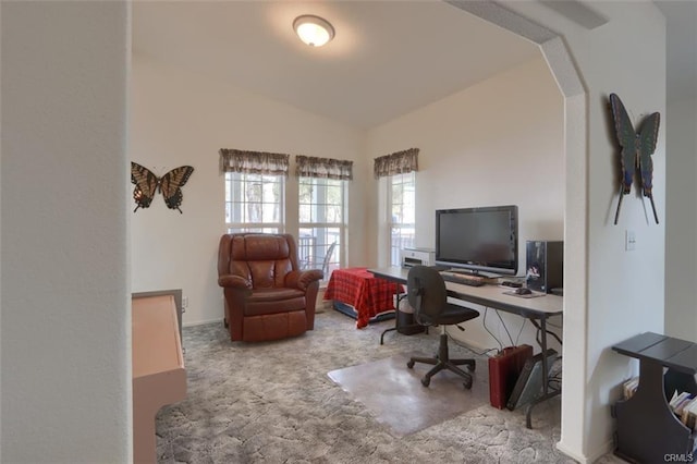 office area featuring carpet and arched walkways