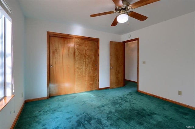 unfurnished bedroom with carpet, baseboards, ceiling fan, and a closet