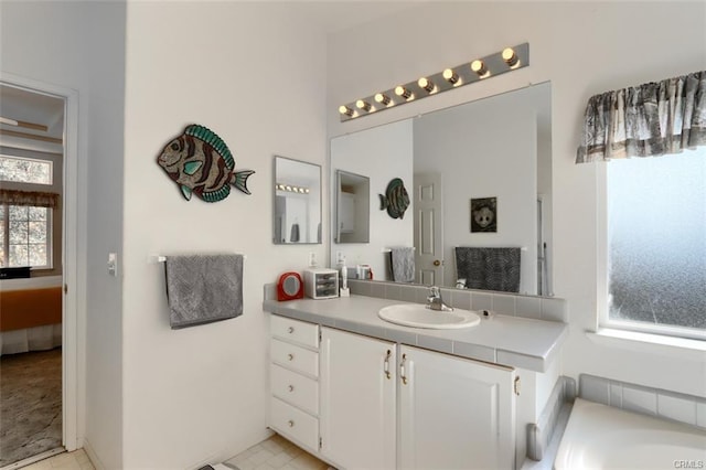 bathroom featuring vanity and ensuite bathroom