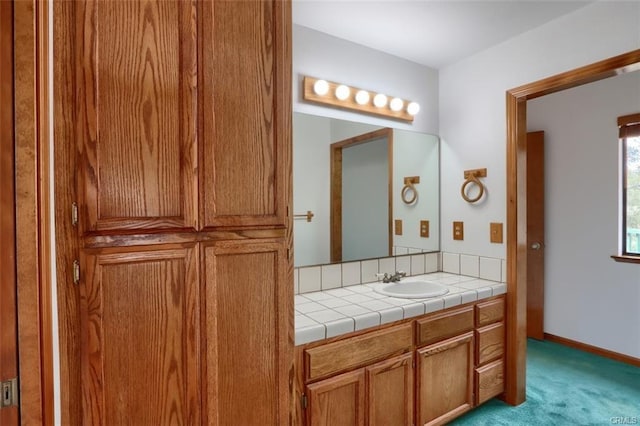 bathroom with vanity and baseboards