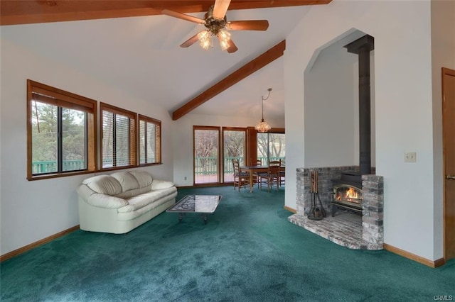 unfurnished living room with a wood stove, carpet flooring, vaulted ceiling with beams, and a healthy amount of sunlight