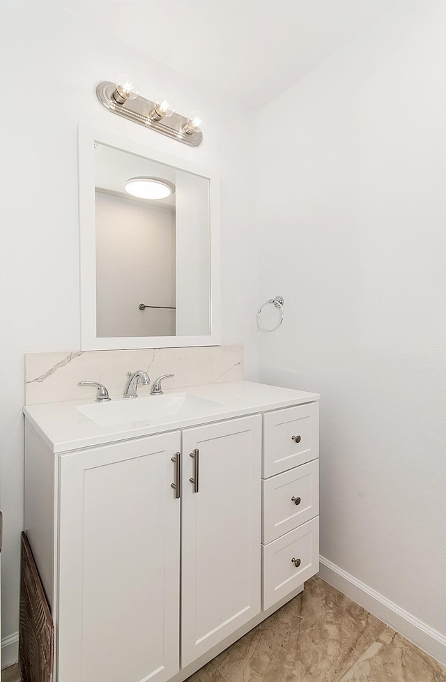 bathroom with vanity and baseboards