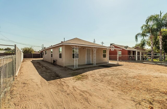 back of house featuring a patio area, a fenced backyard, and stucco siding