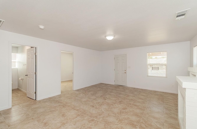 spare room featuring baseboards and visible vents