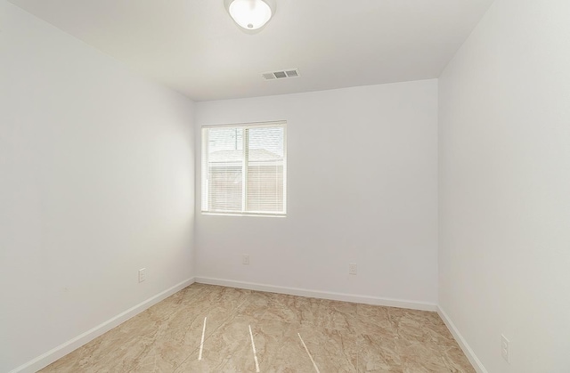 unfurnished room with visible vents and baseboards