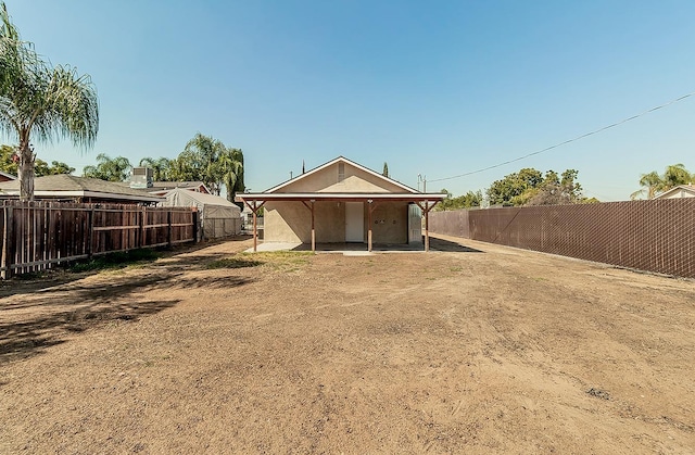 rear view of property with a fenced backyard and a patio