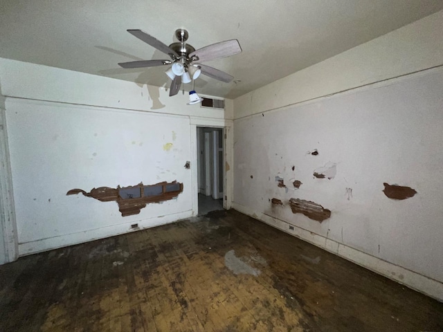 interior space with ceiling fan, wood finished floors, and visible vents