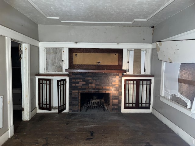 unfurnished living room featuring hardwood / wood-style floors, a fireplace, baseboards, and a textured ceiling