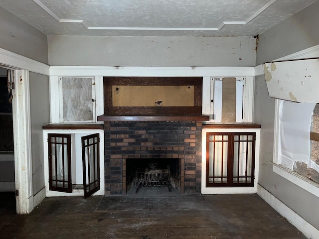 unfurnished living room featuring a textured ceiling and a brick fireplace