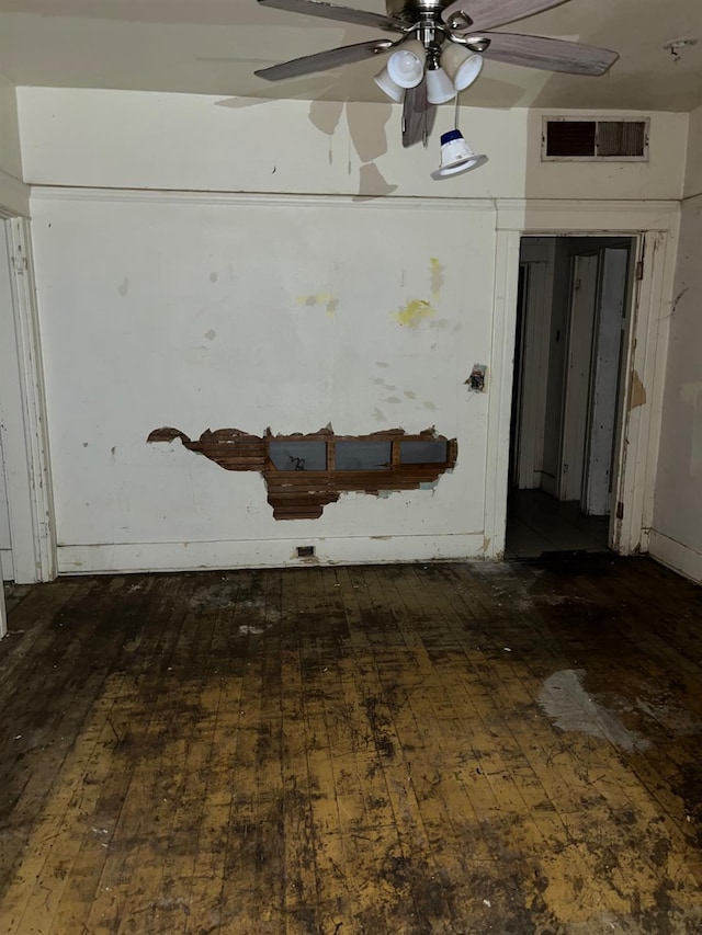 interior space with visible vents, ceiling fan, and hardwood / wood-style flooring