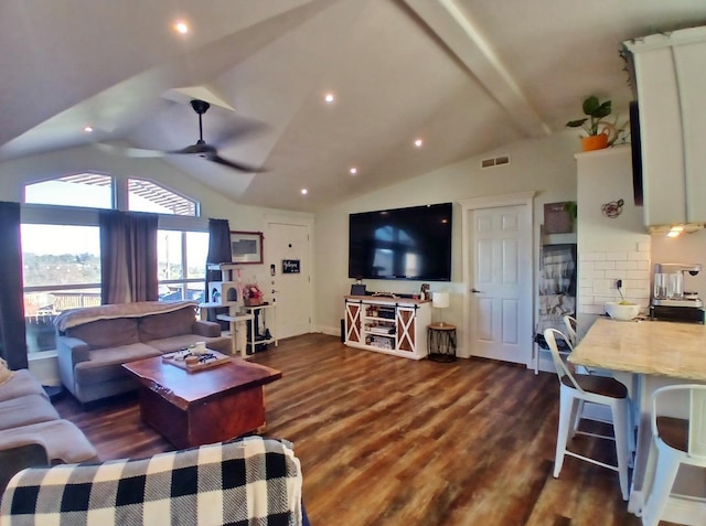 living room featuring lofted ceiling with beams, dark wood-style flooring, visible vents, and a ceiling fan