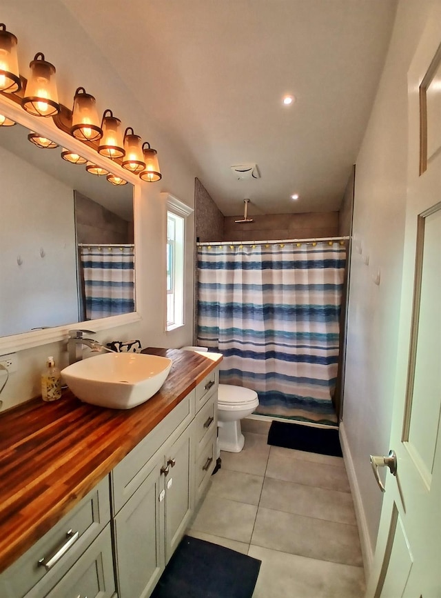 full bathroom featuring baseboards, toilet, a shower with curtain, tile patterned flooring, and vanity