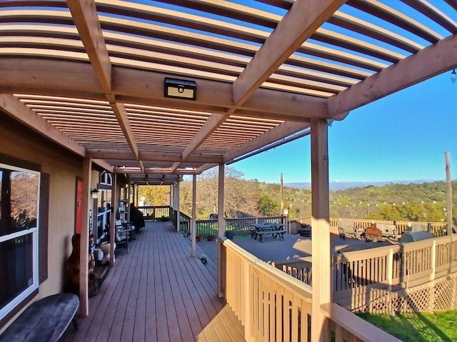 wooden deck featuring a pergola