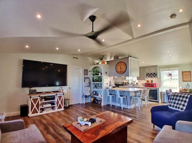 living room with lofted ceiling, visible vents, wood finished floors, and recessed lighting