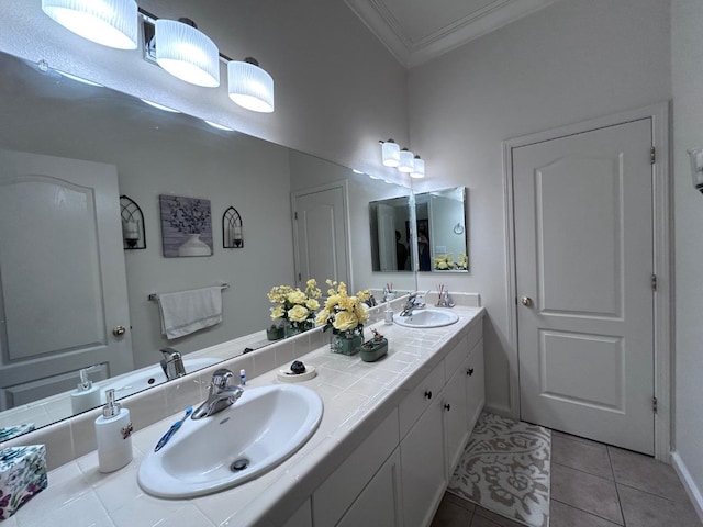 full bathroom with ornamental molding, tile patterned flooring, a sink, and double vanity