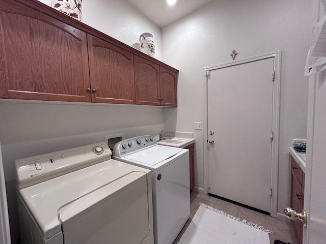 laundry room featuring cabinet space, light tile patterned floors, a sink, and independent washer and dryer